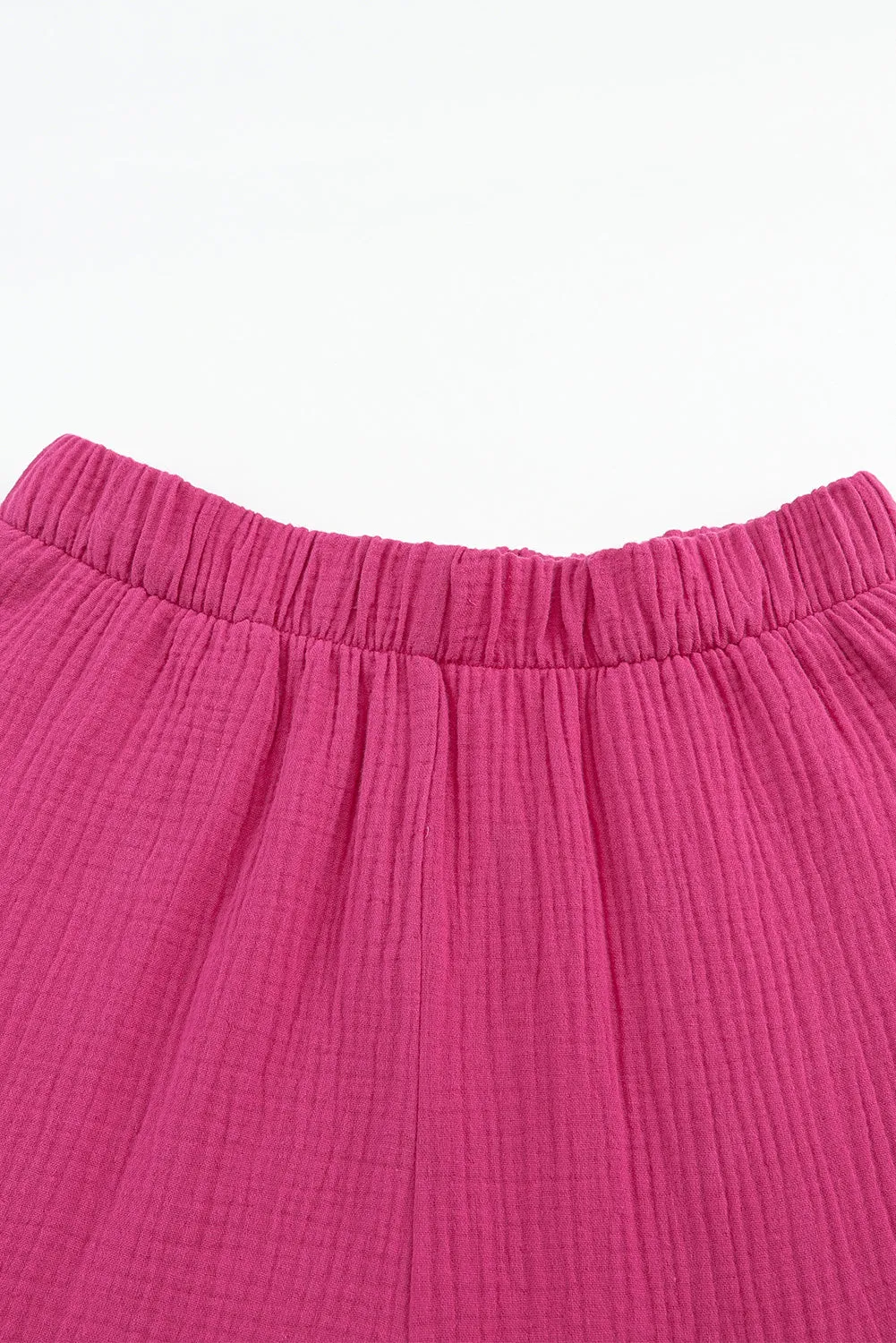 Pantalon taille haute texturé rose à volants et cloche